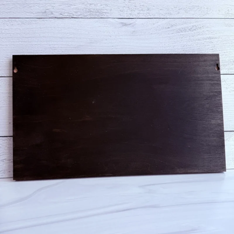Rear view of the dark wood backing showing the built-in side hanging notches for wall mounting.