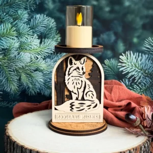 Fox woodland candle holder on a wood slice with deep teal pine background and rust cloth with dark fall berries and autumn leaves