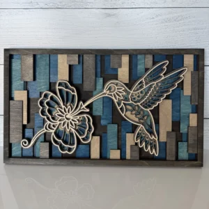 Front view of six-layer wood art featuring a hummingbird, flower, and geometric background in cool desert colors.