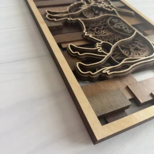 Side angle close-up showing stacked maple layers and mandala engraving depth on highland cow wall art