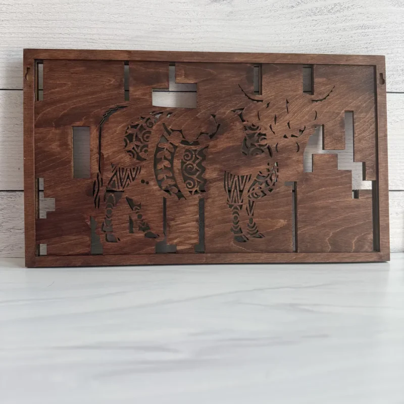 Back view of highland cow wall art showing Desert Walnut closed backer, cutout silhouette, and keyhole hangers