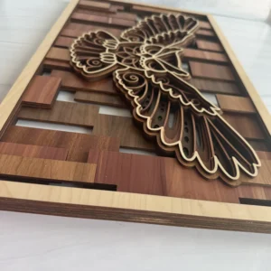 Angled close-up of owl layered wall art showing stacked wood species layers and mandala engraving detail