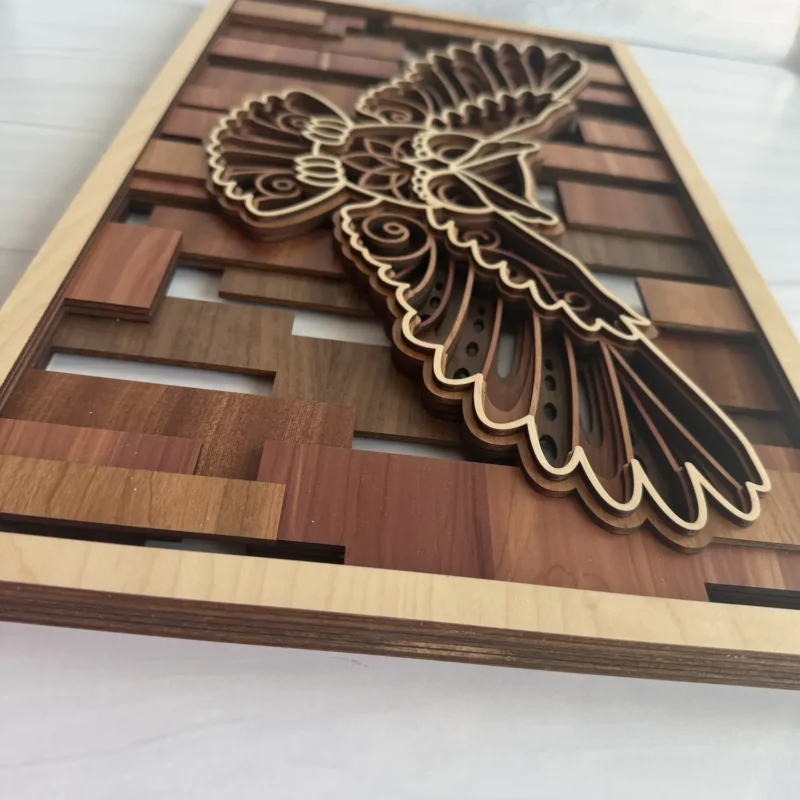 Angled close-up of owl layered wall art showing stacked wood species layers and mandala engraving detail