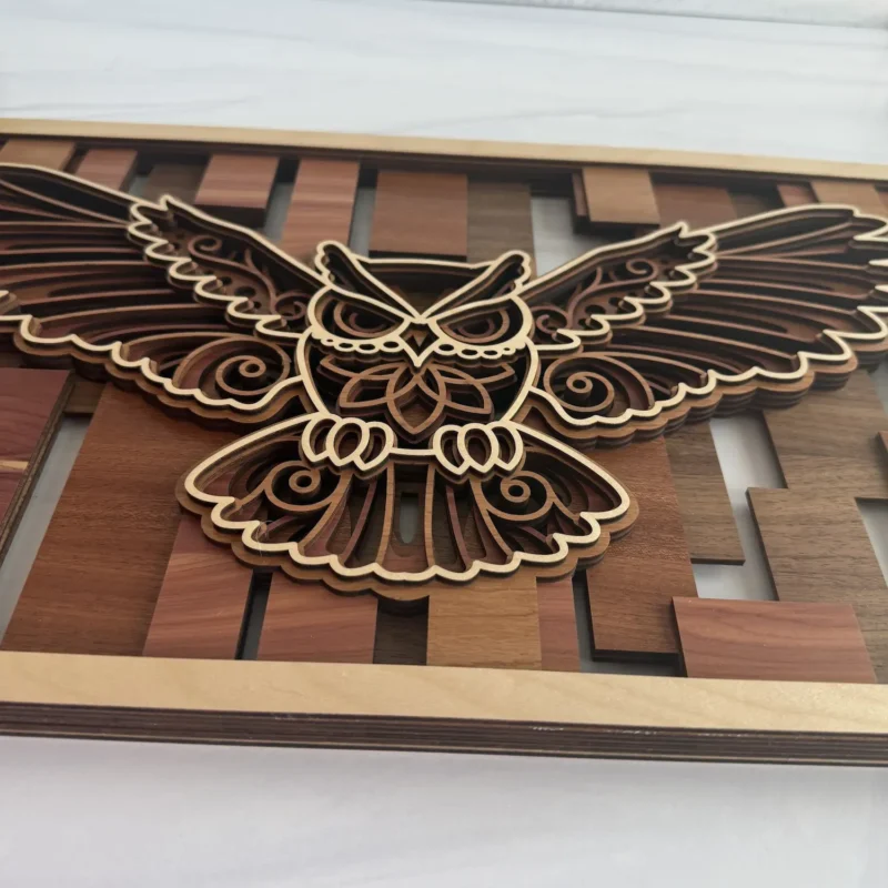 Side profile of flying owl layered wall art showing stacked layer depth and natural maple frame edge