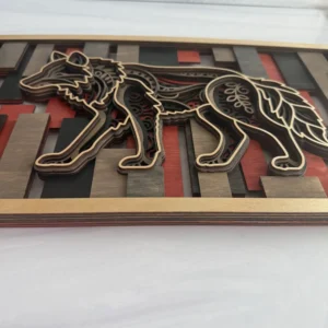 Side profile detail of wolf layered wall art showing stacked maple layers, mandala engravings, and red and black stained mosaic background