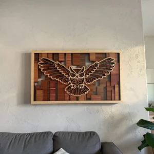 Owl layered wall art hanging on a textured wall above a gray sofa showing true scale in a living room