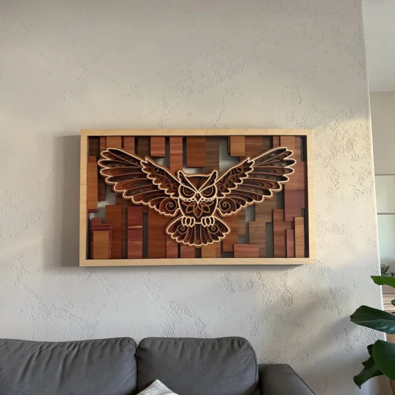 Owl layered wall art hanging on a textured wall above a gray sofa showing true scale in a living room