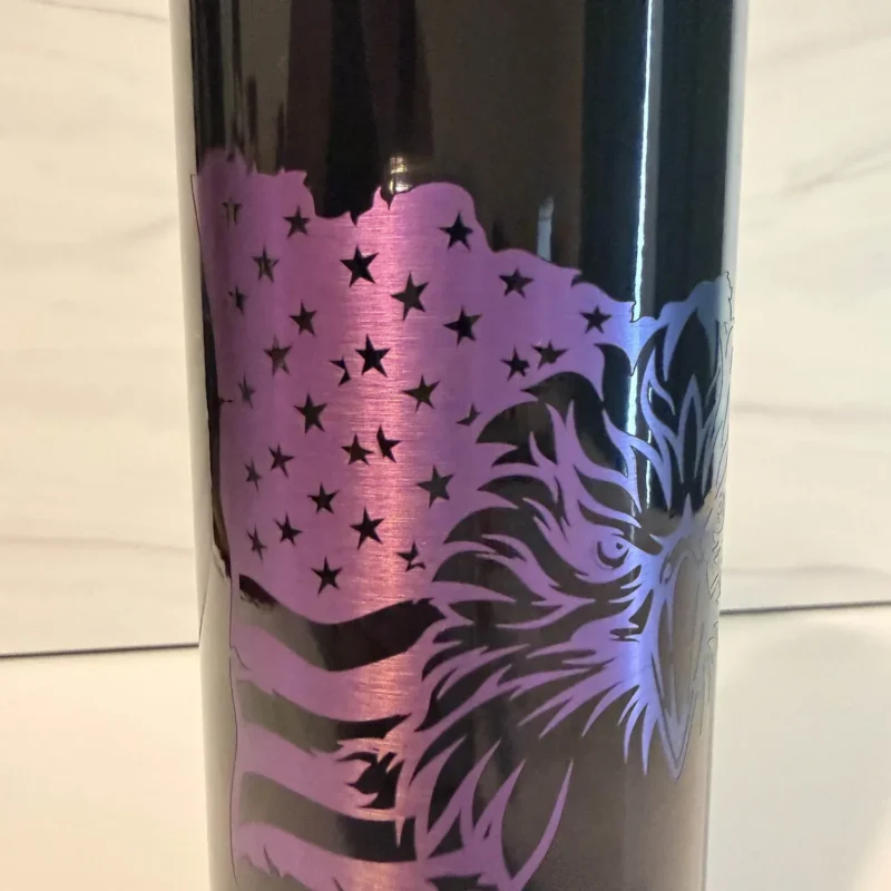 Close-up of laser-engraved American flag and stars on black electroplated 20 oz skinny tumbler with purple and rainbow metallic reveal