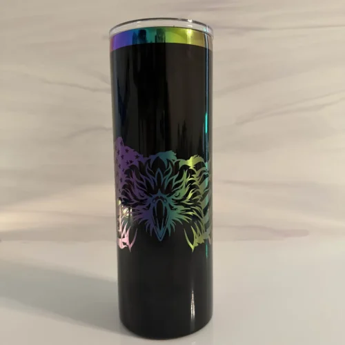 Front view of black electroplated skinny tumbler with wrap-around bald eagle laser engraving in rainbow metallic finish, clear sliding lid