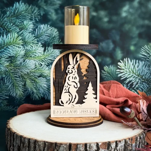 Rabbit woodland candle holder on a wood stump with deep teal pine background and rust fall cloth and berries