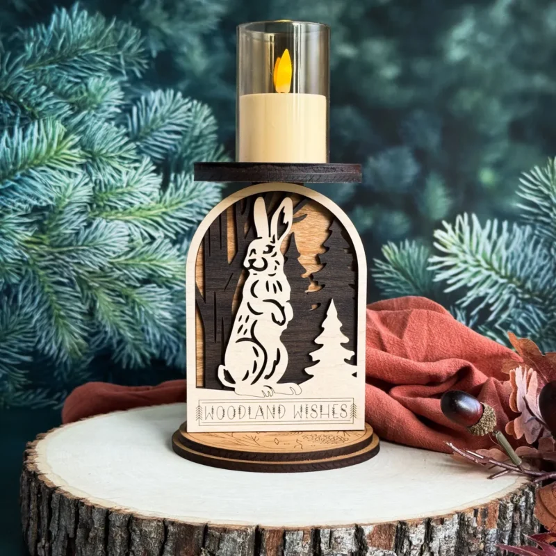 Rabbit woodland candle holder on a wood stump with deep teal pine background and rust fall cloth and berries