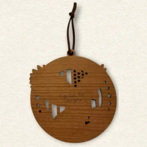 Back of the round wooden ornament showing the natural wood grain, an attached brown hanging cord, and “Cactus Air Designs” laser engraved in a delicate single-line font.