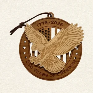 Round two-layer wooden ornament with "United States of America" and "250 Years of Freedom" engraved on the border, featuring a laser-cut flag with cut-through stripes and star field, topped with a detailed bald eagle coming in for a landing, hung on a brown cord