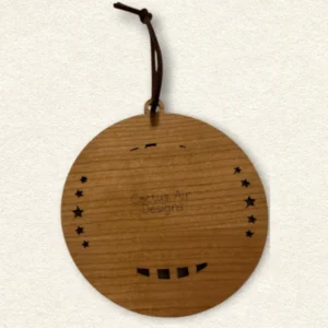 Back of the round wooden ornament showing the natural wood grain, an attached brown hanging cord, and “Cactus Air Designs” laser engraved in a delicate single-line font.