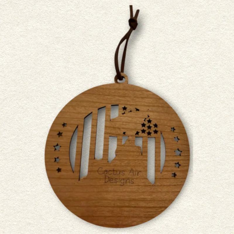 Back of the round wooden ornament showing the natural wood grain, an attached brown hanging cord, and “Cactus Air Designs” laser engraved in a delicate single-line font.