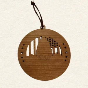 Back of the round wooden ornament showing the natural wood grain, an attached brown hanging cord, and “Cactus Air Designs” laser engraved in a delicate single-line font.