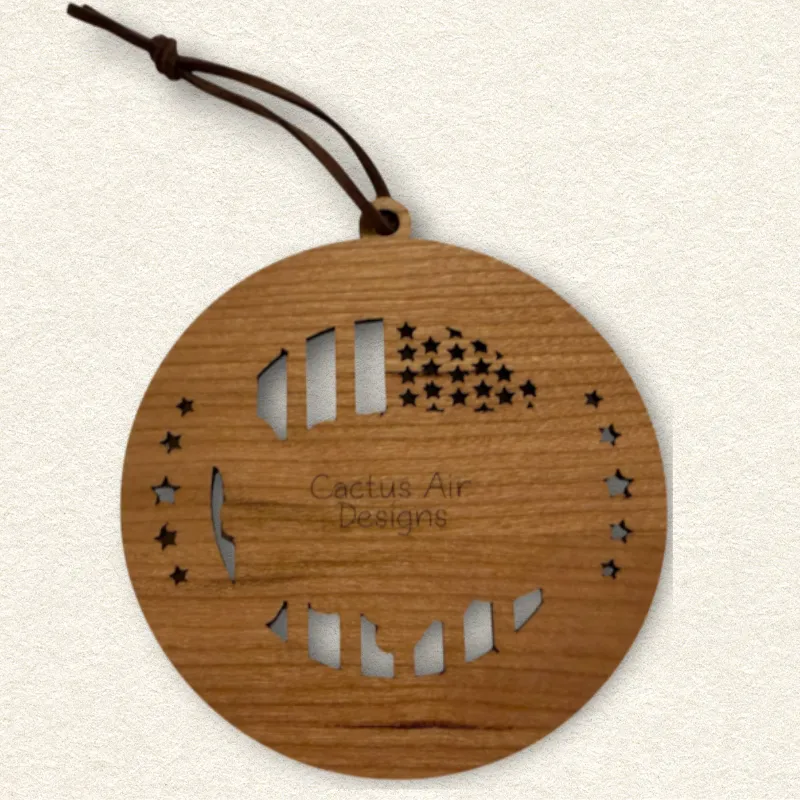 Back of the round wooden ornament showing the natural wood grain, an attached brown hanging cord, and “Cactus Air Designs” laser engraved in a delicate single-line font.