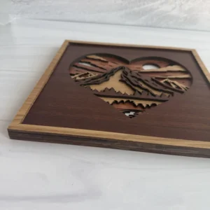 Angled mountain heart showing wood layers, peaks, and cherry frame