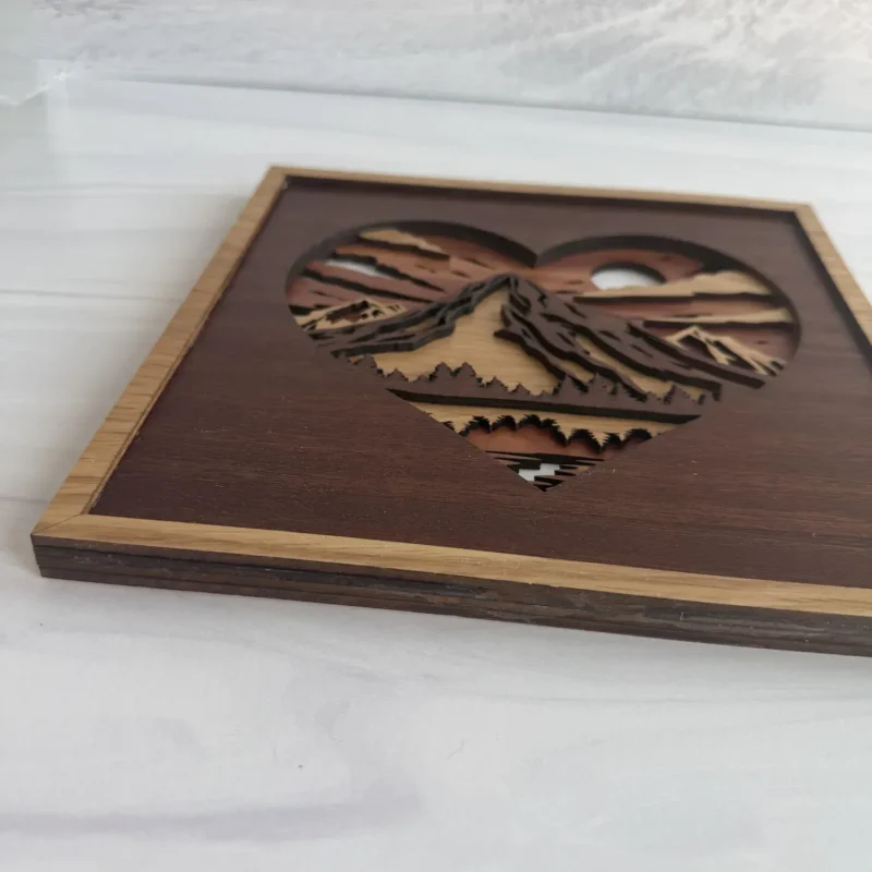 Angled mountain heart showing wood layers, peaks, and cherry frame
