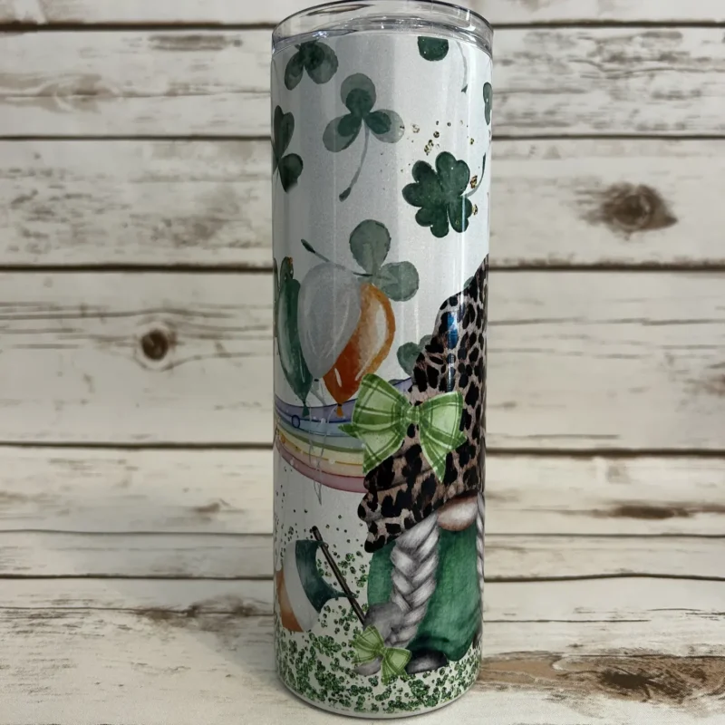 Side view of White Shimmer tumbler displaying female gnome with leopard-print hat, braided hair, and green clover accents.