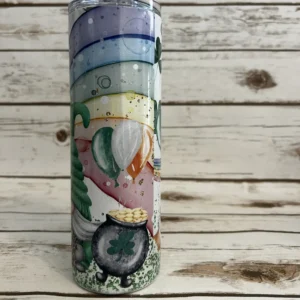 St. Patrick’s Day gnome tumbler on a light wooden background featuring a male gnome with a green knit hat and beard.