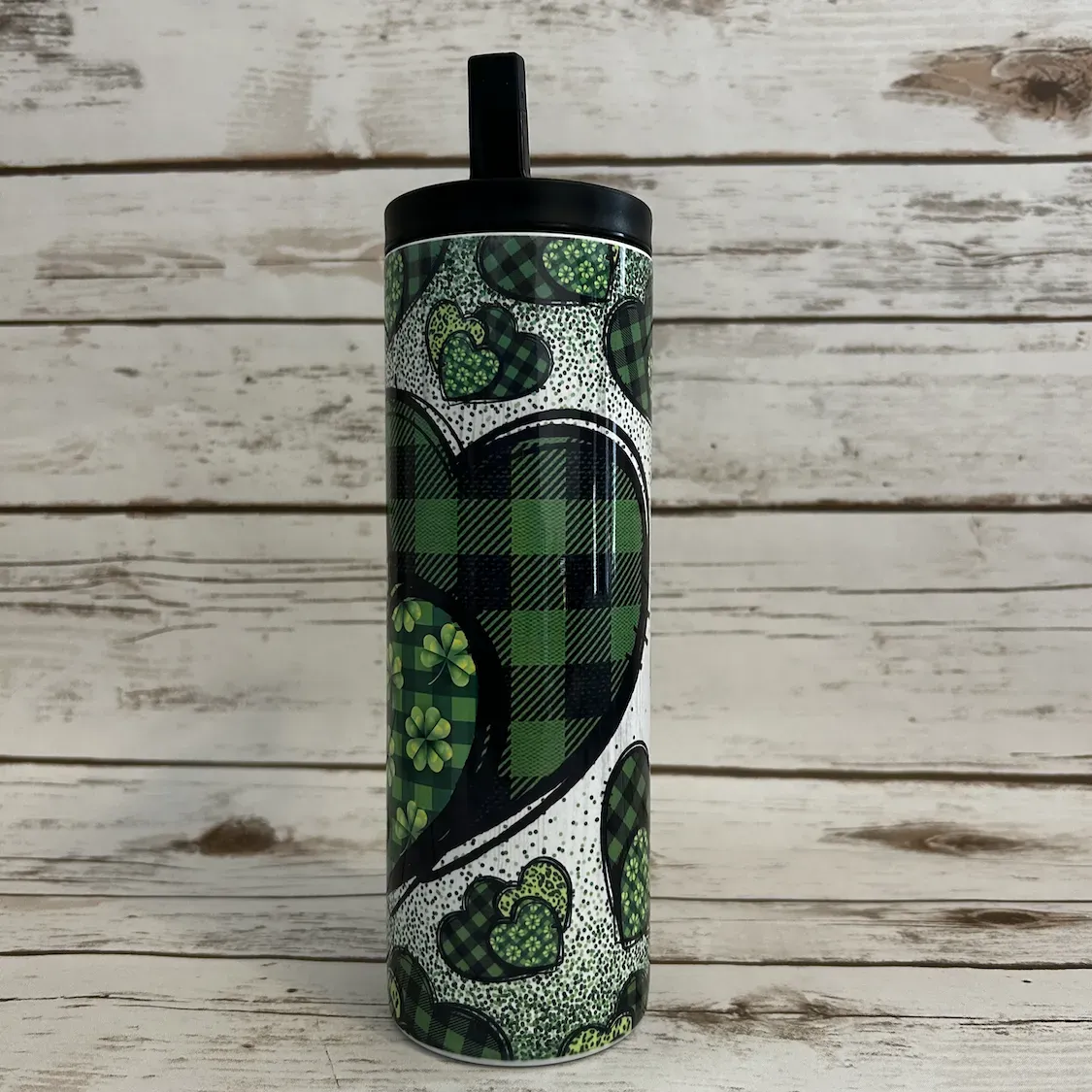 st patricks day gorgeous green heart tumbler that has green buffalo plaid with a sublimated design on a 20oz skinny